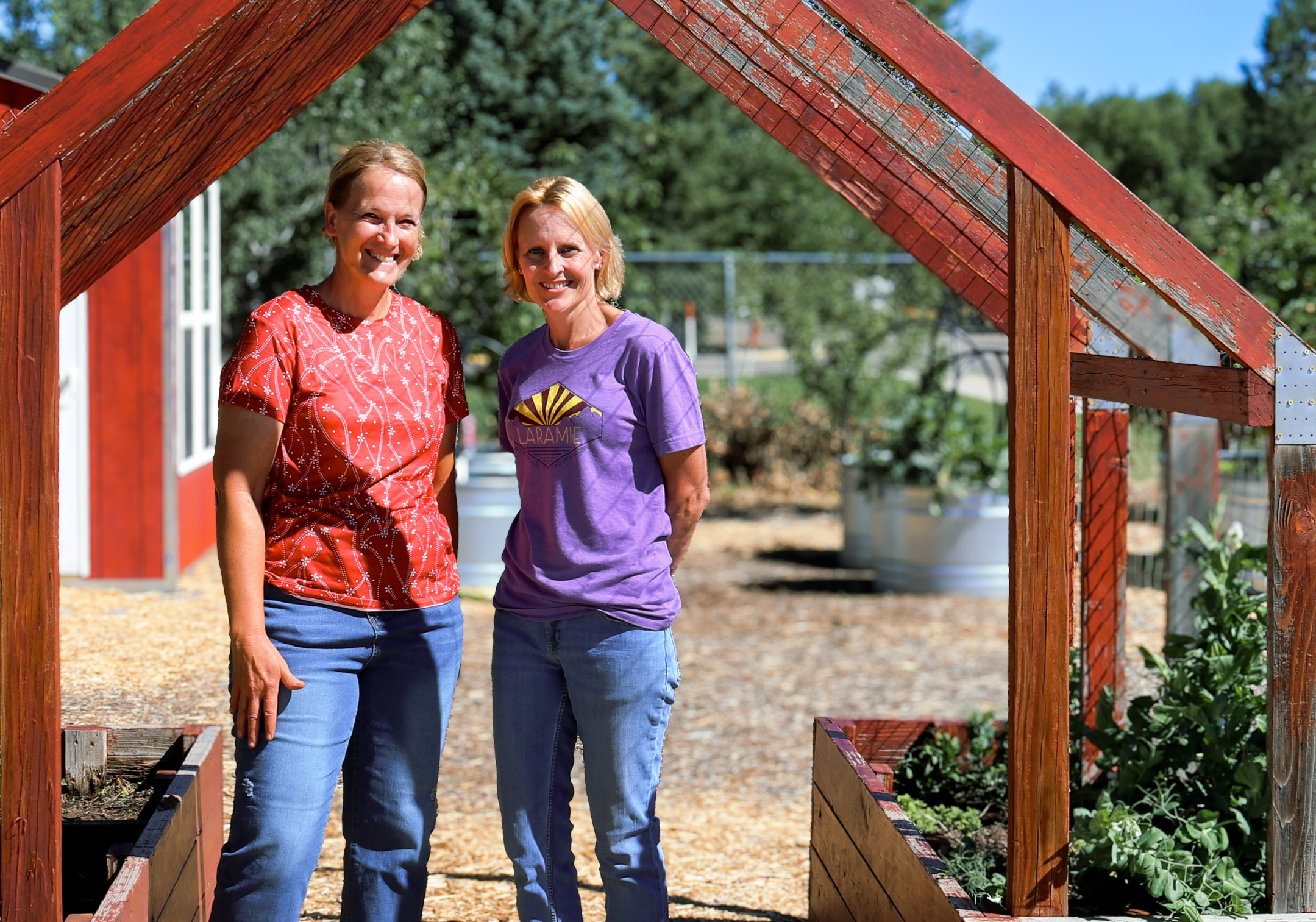 CNP educator Ruth Lake (left) and Linford librarian Stefanie Hunt (right) stand at the entrance to the revitalized garden at Linford Elementary School. Photo by Kali McCrackin Goodenough.