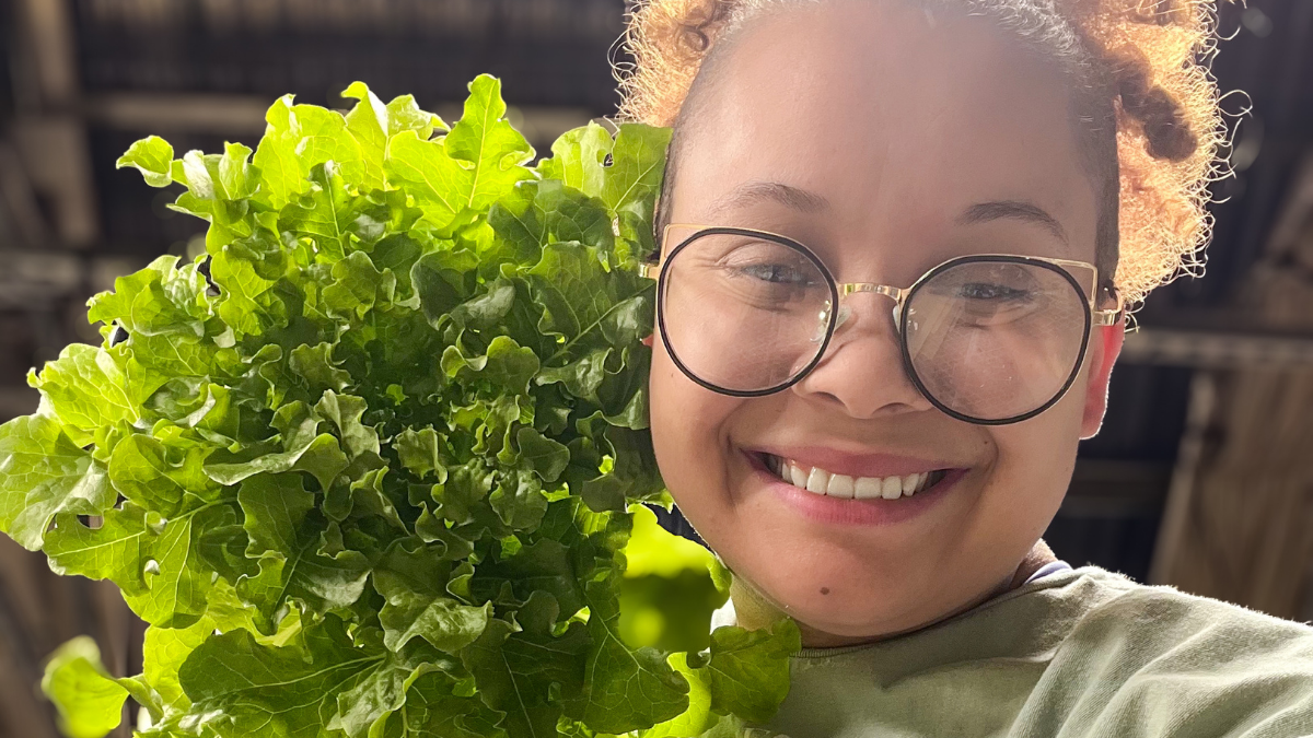 Drew Bree holding lettuce grown for NASA research