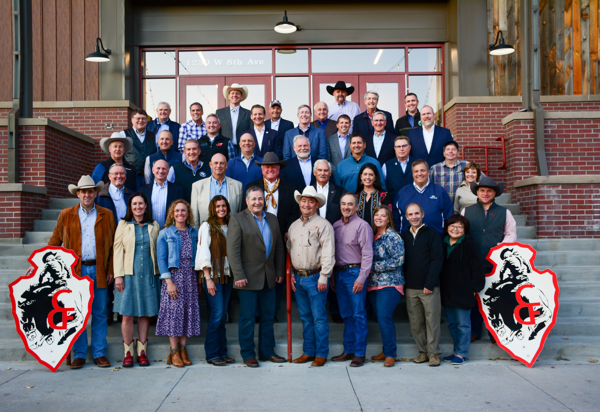 A large group of people standing on the steps of the Cheyenne Frontier Days building