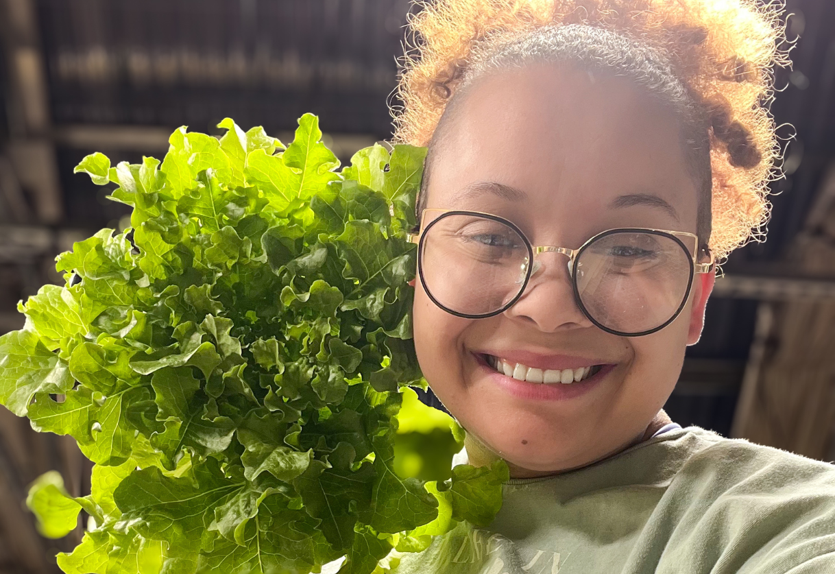 Drew Bree holding lettuce grown for NASA research