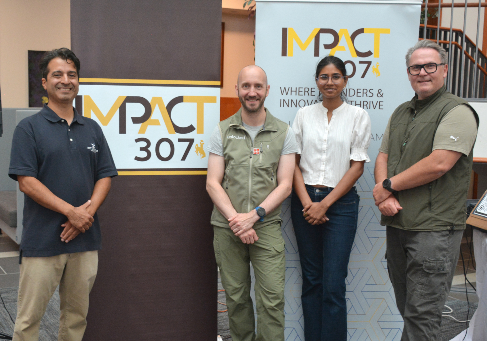 L-R: Nicholas Giraldo, assistant director of IMPACT 307, with Unlocked team members Christoph Geisler, Prerana Balasubramanian, and Michal Luczak.