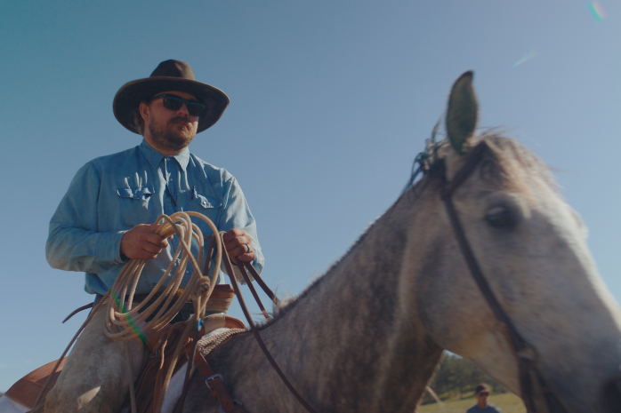 cowboy on horse, looking at the horizon