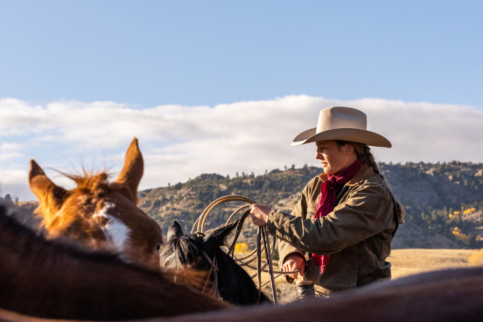 Cowgirl on horse with rope