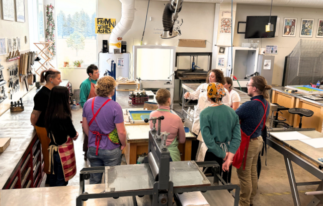 instructor and students in print making studio