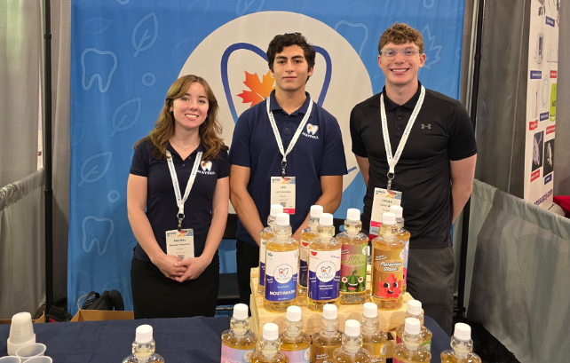 students standing behind dental products at tradeshow