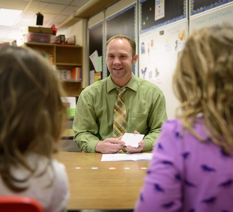 Teacher talking to two children