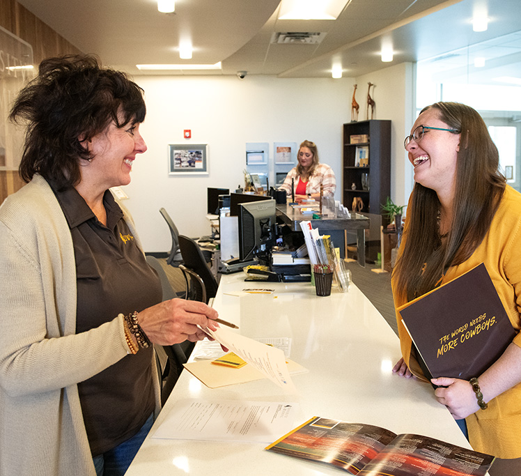 Staff and faculty talking and laughing