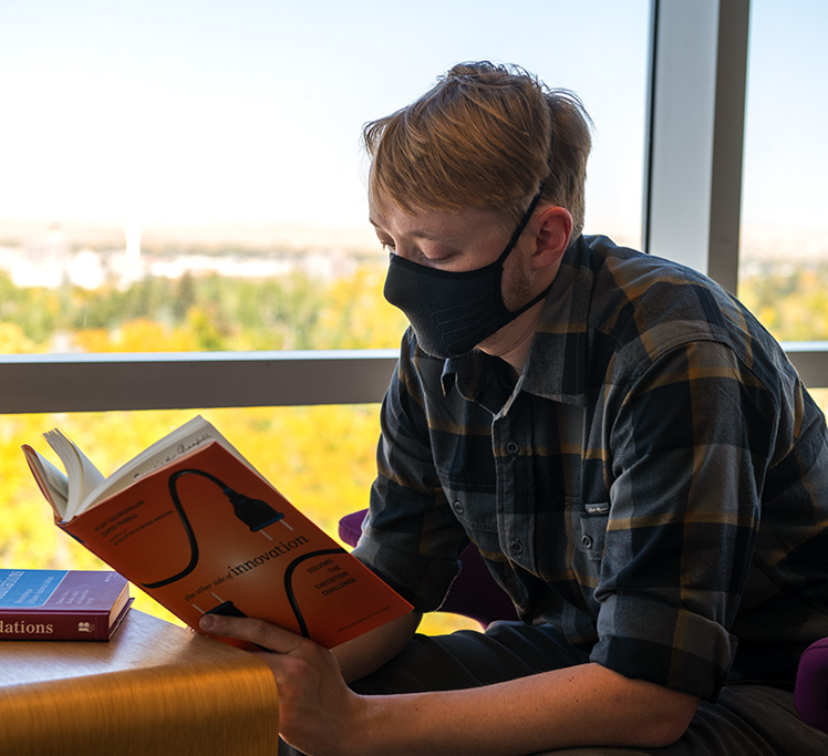 Faculty reading by window