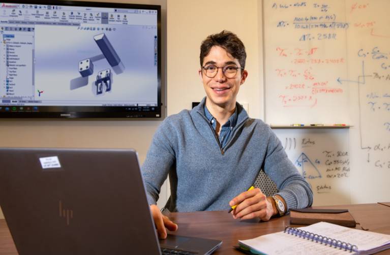 Student solves a complex mathematical equation.