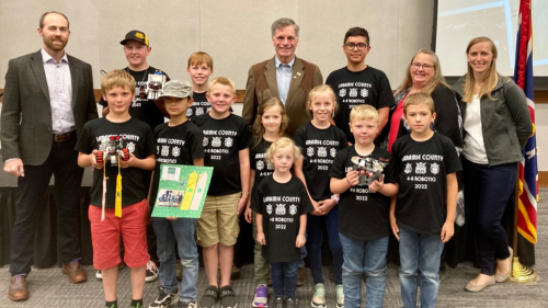 a group of 4-H youth pose with the governor of Wyoming during an awards ceremony