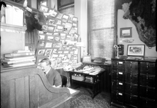 man at desk in the 1907 AES office