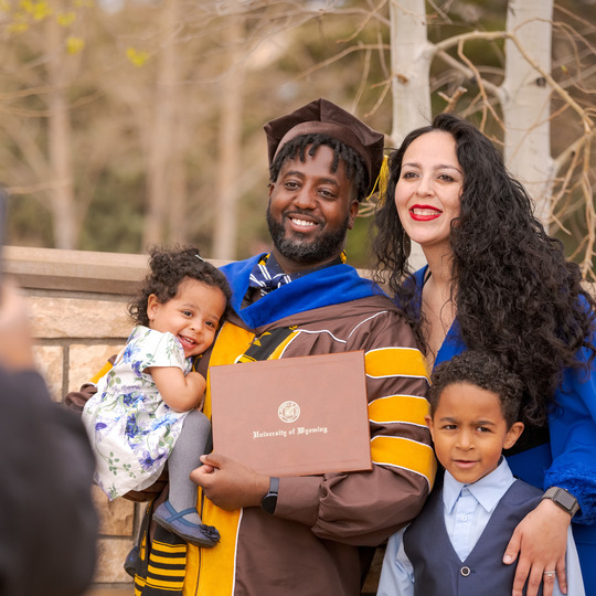 Family celebrating doctoral graduation.