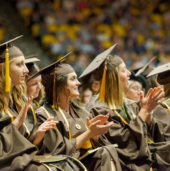 students clapping at graduation