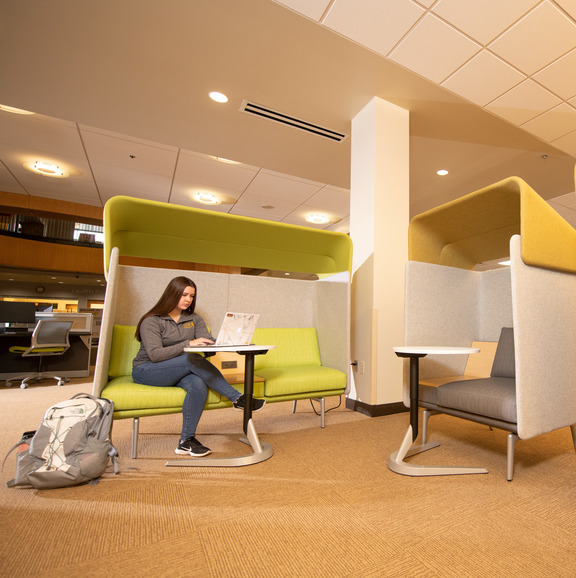 student studying in a nook on campus