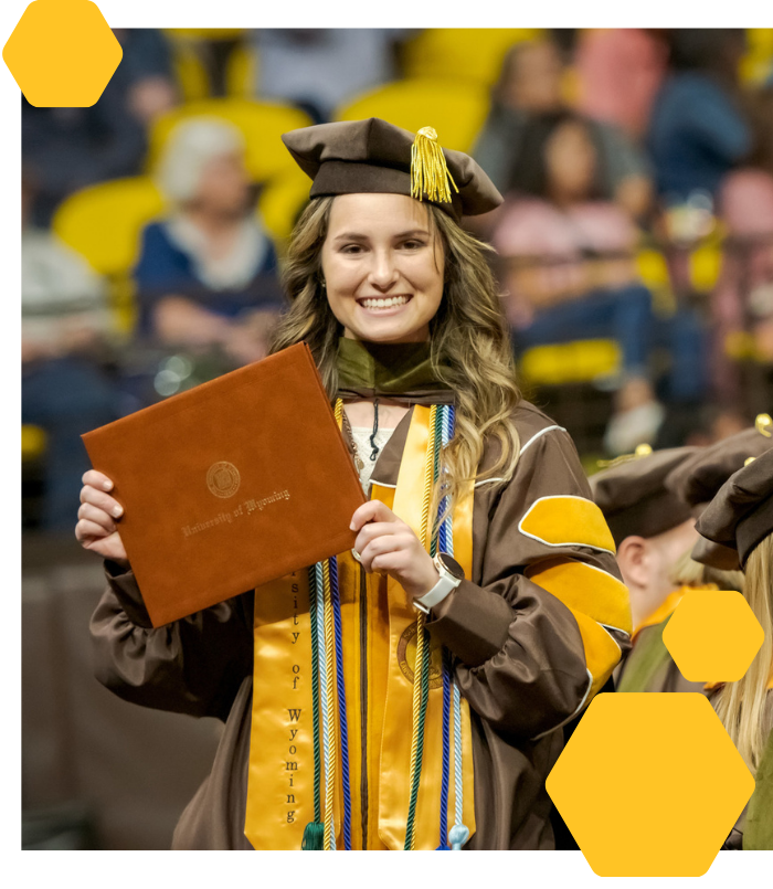 student at graduation with diploma