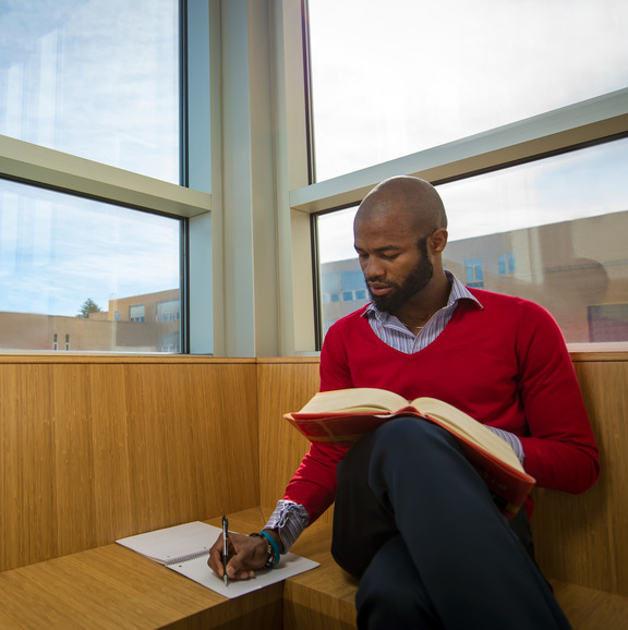 student reading and taking notes