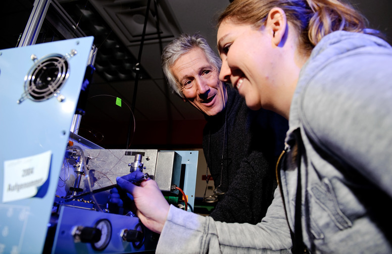 A professor and student work together in a lab