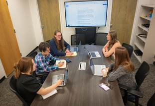 a group of people working in a conference room