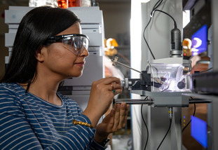 international molecular and cellular life sciences student Kalpana Subedi from Nepal working with a mass spectrometer machine