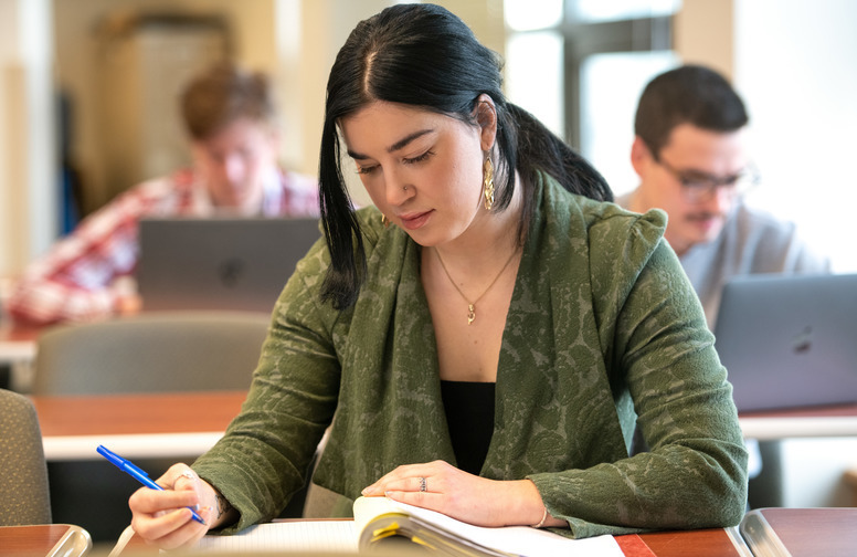 A student writes in a notebook during class
