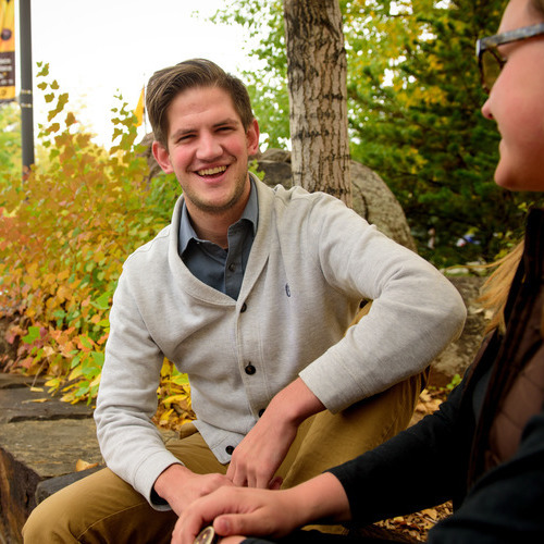 A student laughs for a photo