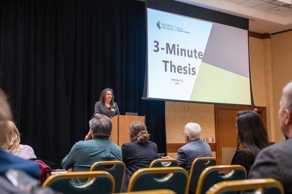 image of Dr. Pepper speaking at 3MT competition. 