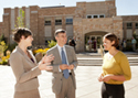 students and faculty talking outside on campus