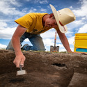 cowboy digging in the sand