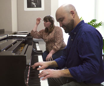 man and woman at a piano