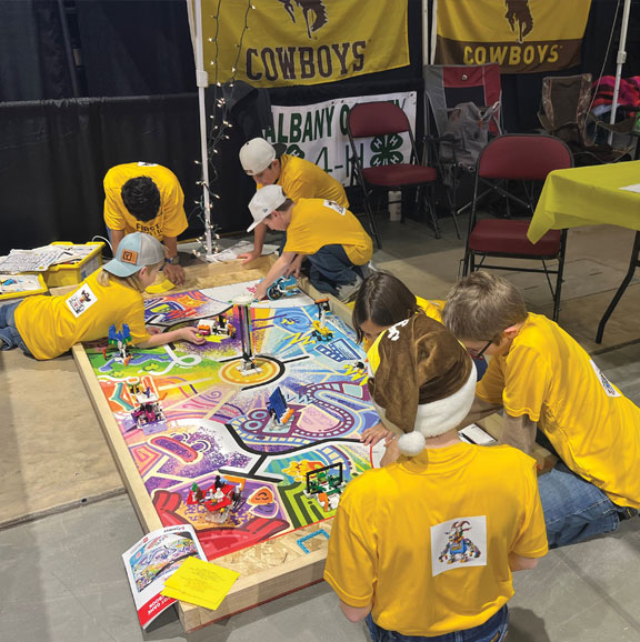 group of young students play a game on the floor