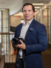 Shane Epping holding his camera in the Gateway Center