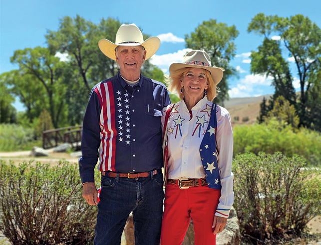 Couple posing outside in patriotic clothes and hats