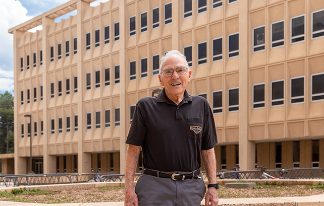 man standing in front of a building on the UW campus