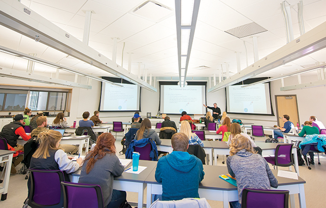 large group of students in a classroom listening to a lecture