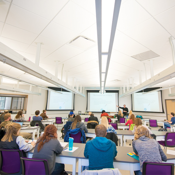 students listening to professor in a classroom