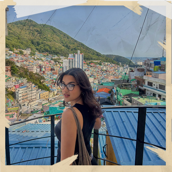 woman posing in front of a cityscape