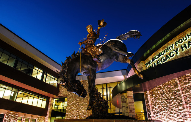 exterior of the Gateway Center at night with horse and rider statue