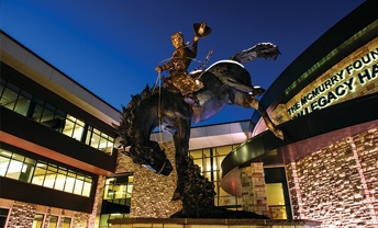 horse and rider statue in Gateway Center building at night