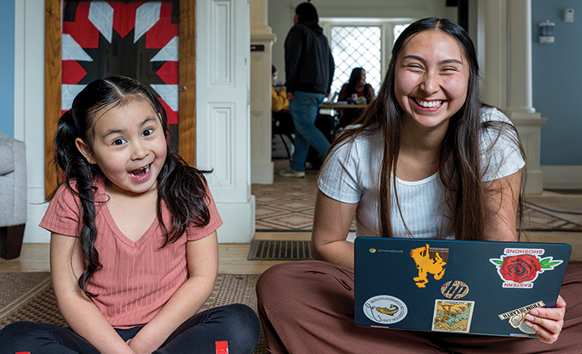 Student and her child studying and playing in the Native American Education, Research and Cultural Center