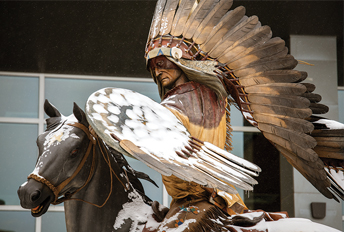 Statue of a Native American chief riding a horse