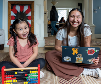Student and her child studying and playing in the Native American Education, Research and Cultural Center
