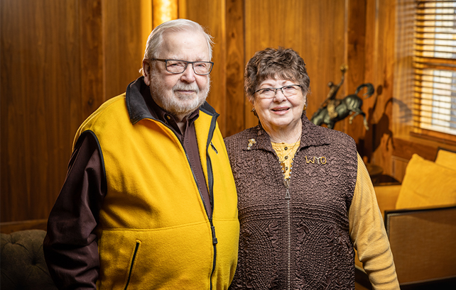 man and woman posing together in a room