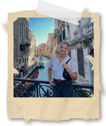 woman standing on a bridge over water in Italy
