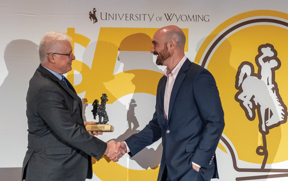 two men in suits shaking hands