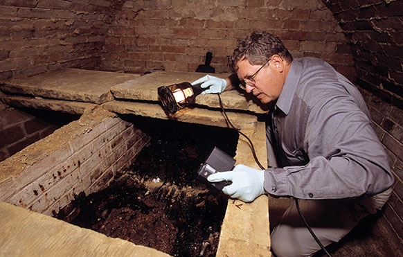 man examining part of an old church in England