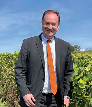 man in a field wearing a suit and tie