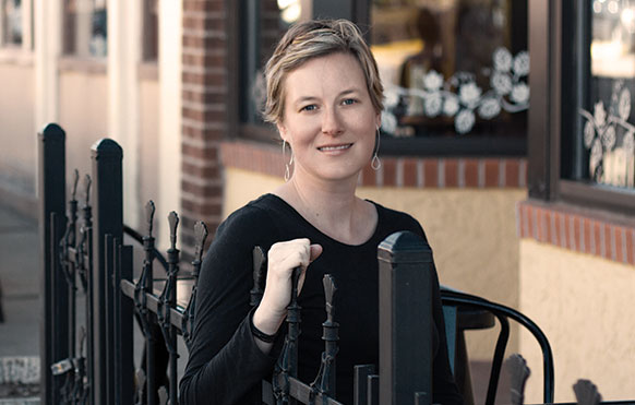 woman sitting at a cafe in a downtown setting