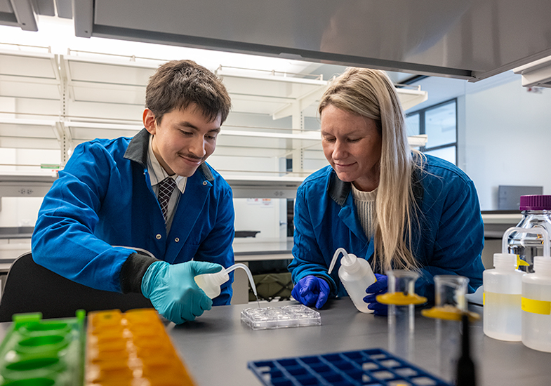 student and professor working in a lab