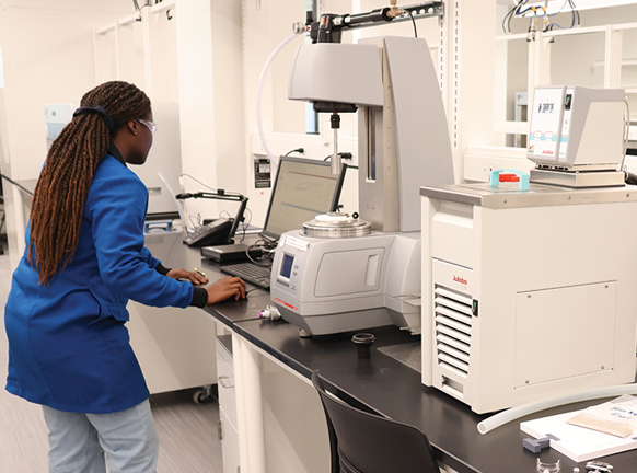 Female student works with equipment in a lab