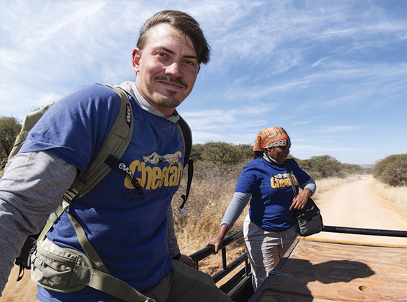 Man and woman riding in the back of a truck in Namibia